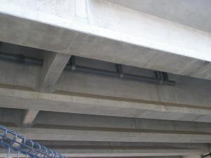 コンクリートで覆われた橋の排水設備を下から撮影した写真