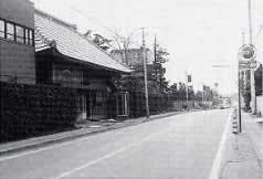 道路左脇に建物や木々が建ち並ぶ東金街道の白黒写真