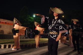 夜に津田沼一丁目公園で阿波踊りを踊っている人たちの写真