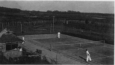 コート内でテニスを楽しんでいる人物の白黒写真
