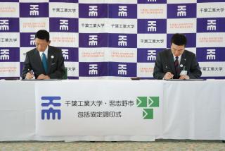 協定書にサインをしている瀬戸熊理事長と宮本市長の写真