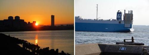 海の向こうに見える建物の間から明るい日が差し込んでいる茜浜初日の出の写真、海上を進んでいる大きな船の写真