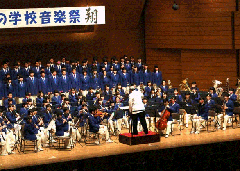 ステージ上で青色の衣装を身にまとった習志野高校吹奏楽部の演奏の様子の写真