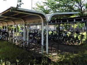 屋根付きの駐輪場に自転車が整列して置かれている習志野市立第七中学校駐輪場の写真