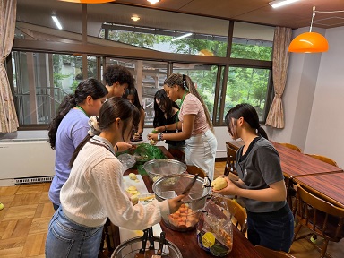 富士吉田青年の家でタスカルーサと習志野の高校生が一緒に食事を作っている様子の写真