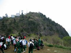 山頂付近で中学生の生徒たちが集まっている写真